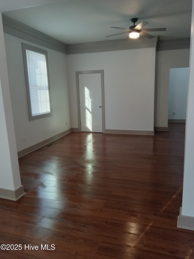 spare room featuring ceiling fan, dark hardwood / wood-style floors, and ornamental molding