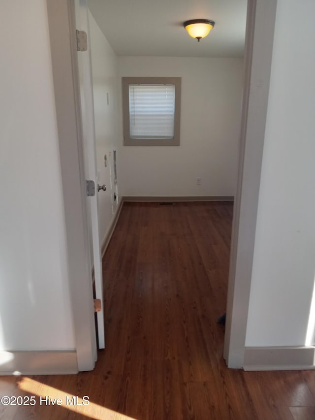 hallway with dark wood-type flooring