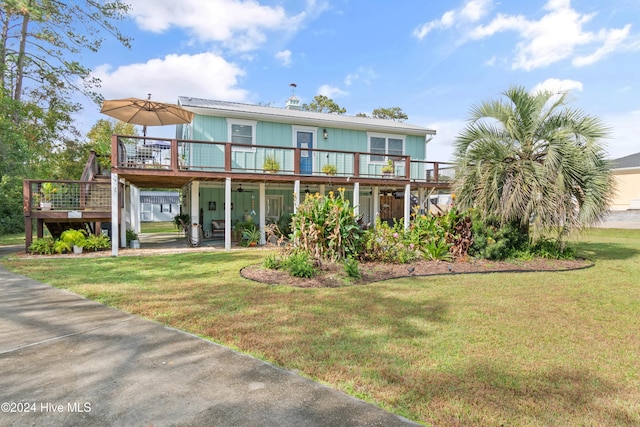 back of property featuring a yard and a deck