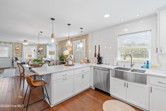 kitchen with white cabinets, wood-type flooring, pendant lighting, and dishwasher