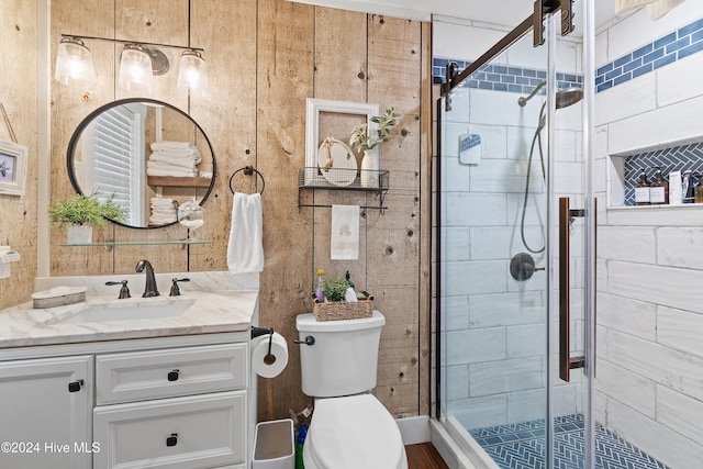 bathroom with vanity, toilet, and an enclosed shower