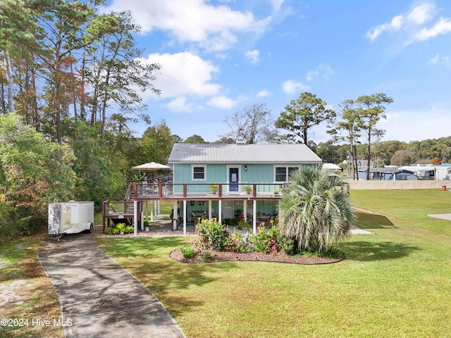 beach home featuring a front lawn