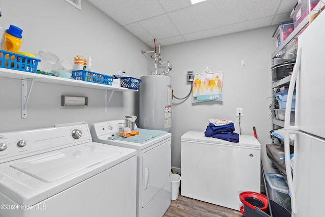 washroom with dark wood-type flooring, separate washer and dryer, and gas water heater