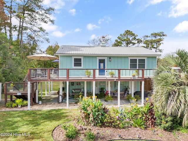 back of property with a patio, a yard, and a deck