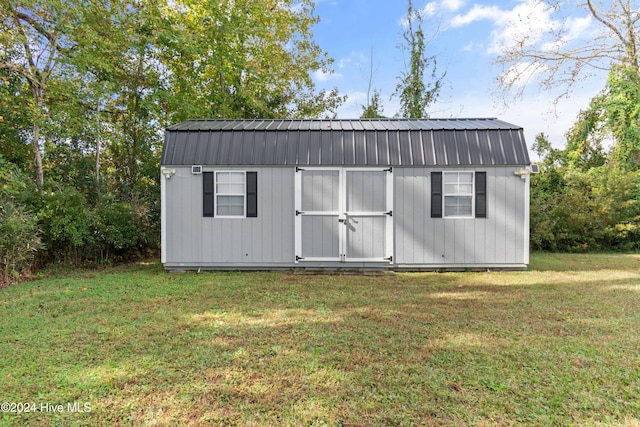 view of outbuilding featuring a yard