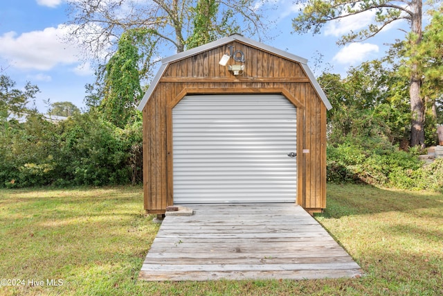 view of outbuilding featuring a garage and a yard