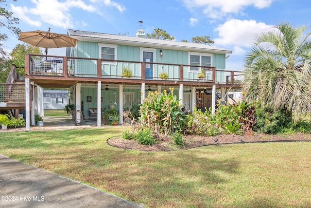 rear view of property with a lawn