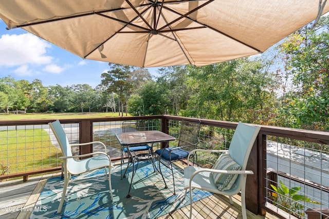 wooden deck with a lawn