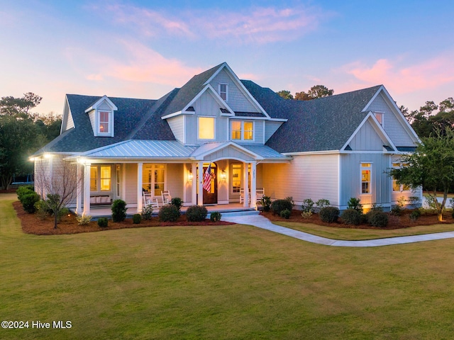 view of front of home with a yard and a porch