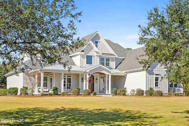 view of front of house featuring covered porch and a front yard