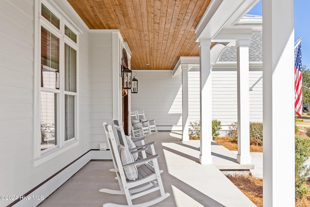 view of patio / terrace featuring a porch and baseboard heating