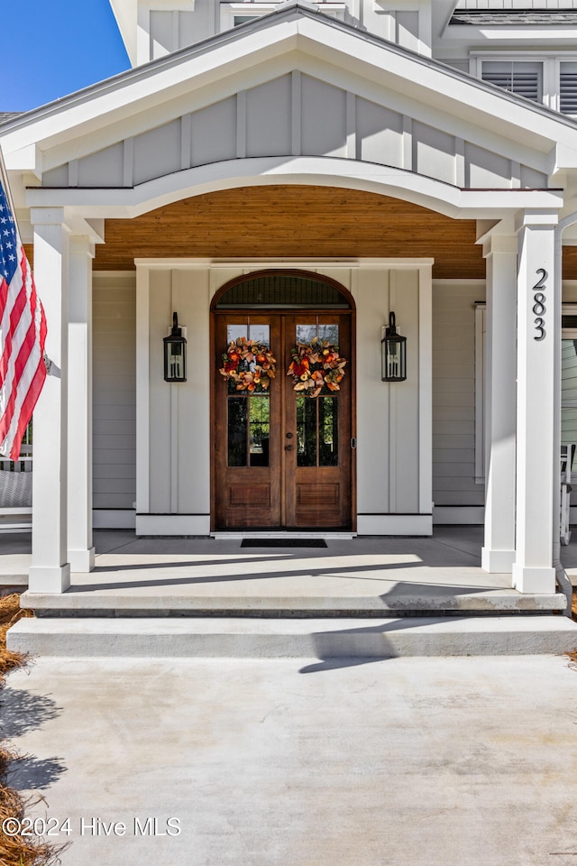 entrance to property with covered porch and french doors