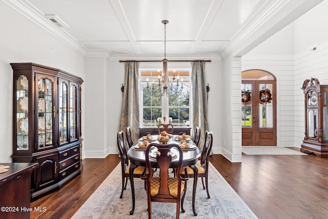 dining area with a chandelier, ornamental molding, dark wood-type flooring, and coffered ceiling