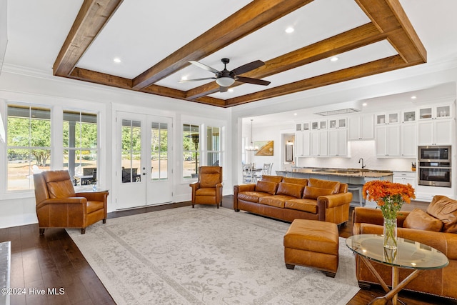 living room with french doors, ceiling fan, ornamental molding, beam ceiling, and dark hardwood / wood-style flooring