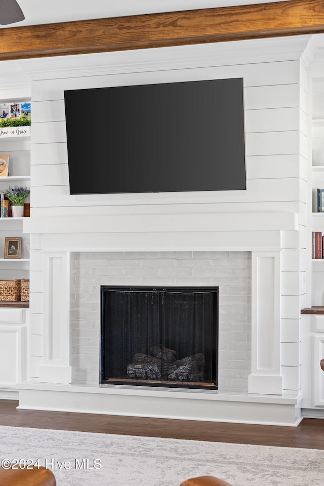 interior details featuring hardwood / wood-style flooring, built in features, and beamed ceiling