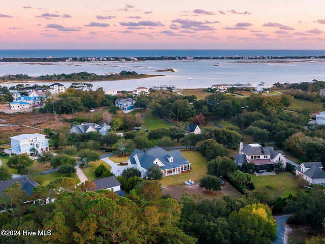 aerial view at dusk with a water view