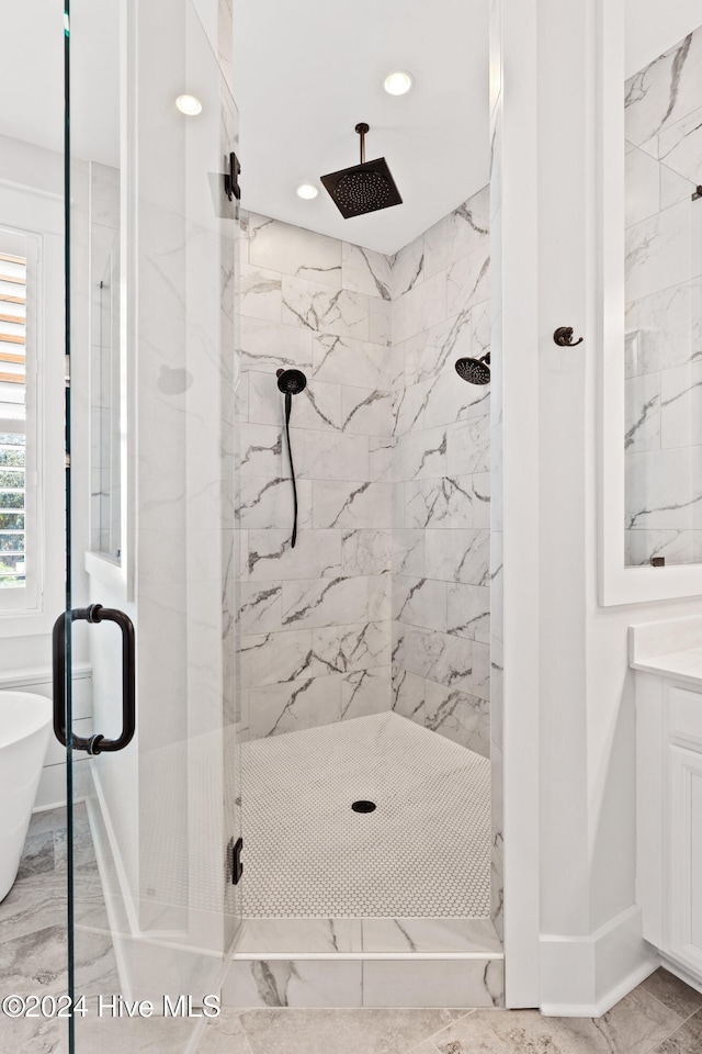 bathroom featuring plus walk in shower and vanity