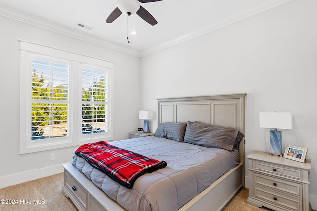 bedroom featuring light carpet, crown molding, and ceiling fan