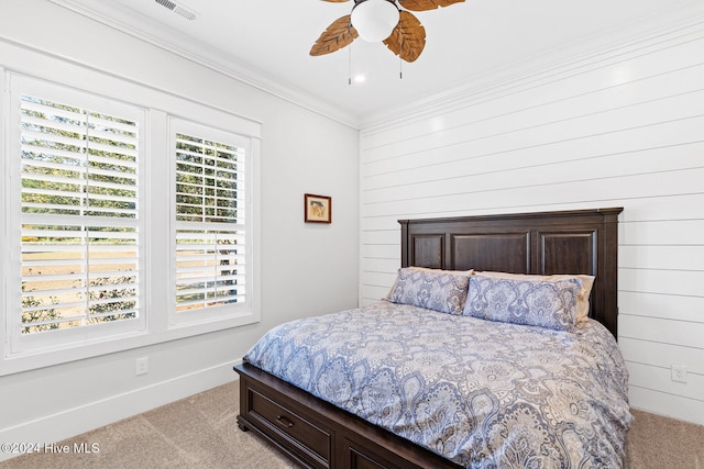 bedroom with ceiling fan, light colored carpet, and ornamental molding