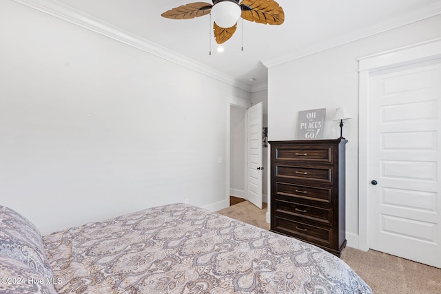 carpeted bedroom with ceiling fan and crown molding