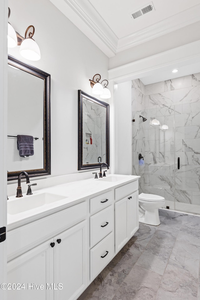 bathroom with vanity, toilet, ornamental molding, and a shower with door