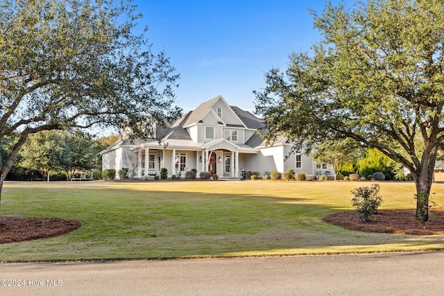 craftsman-style house with covered porch and a front yard