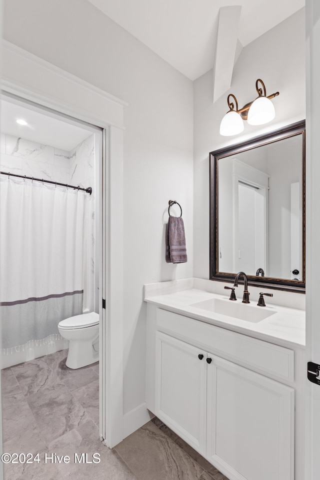 bathroom with vanity, toilet, and walk in shower