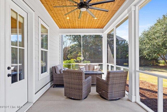 sunroom / solarium with ceiling fan and wood ceiling