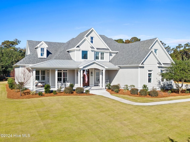 view of front of property featuring covered porch and a front yard