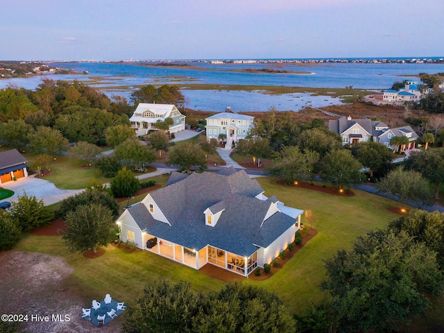 birds eye view of property with a water view