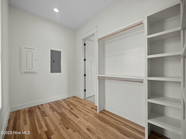 interior space featuring electric panel and light wood-type flooring