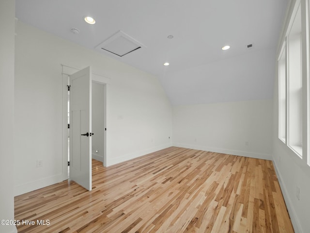 additional living space featuring lofted ceiling and light hardwood / wood-style flooring