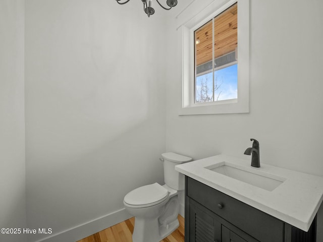 bathroom featuring hardwood / wood-style floors, vanity, and toilet