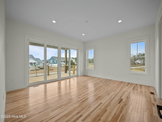 spare room featuring light wood-type flooring