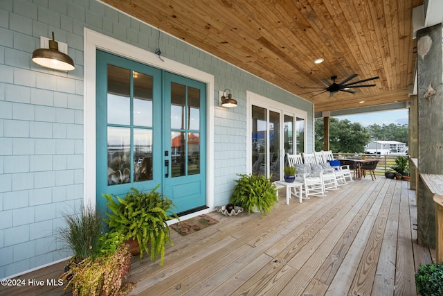 deck with covered porch and ceiling fan