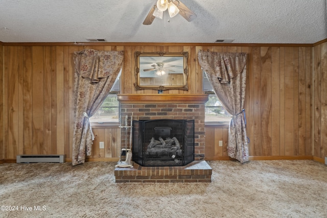 unfurnished living room with wooden walls, a textured ceiling, a baseboard radiator, and a healthy amount of sunlight