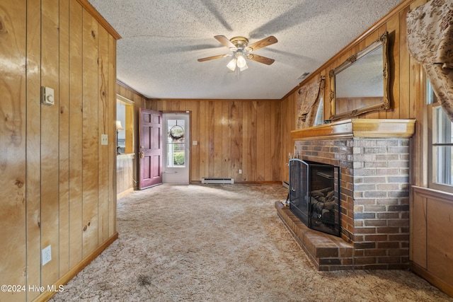 unfurnished living room with light carpet, a textured ceiling, baseboard heating, and wood walls