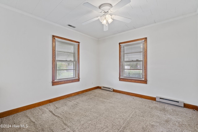 carpeted empty room with a wealth of natural light, a baseboard heating unit, and crown molding