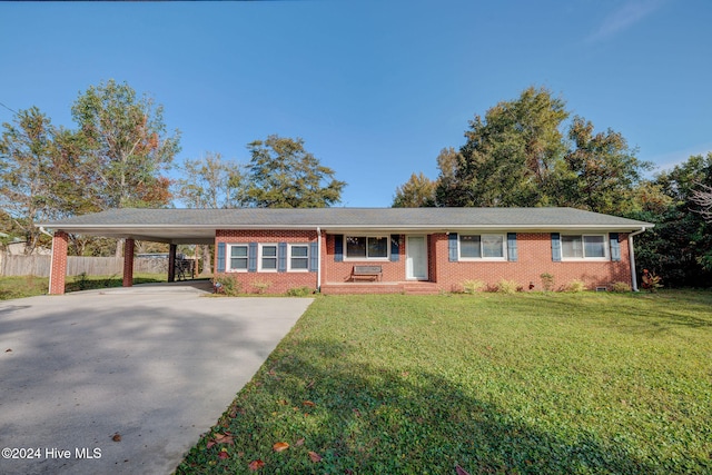 ranch-style house featuring a carport and a front yard