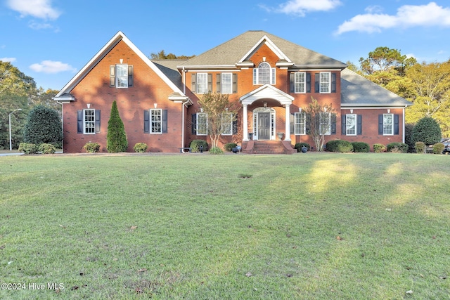 colonial home with a front lawn