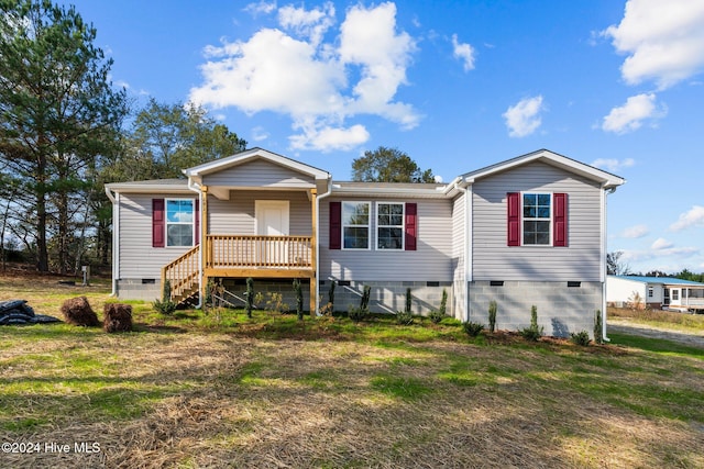 rear view of property featuring a yard