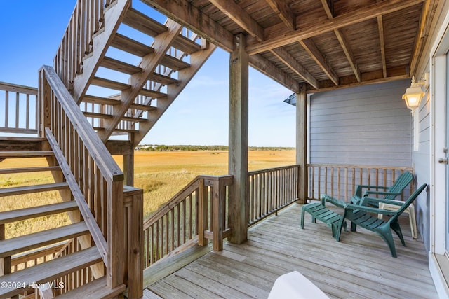 wooden deck with stairs and a rural view