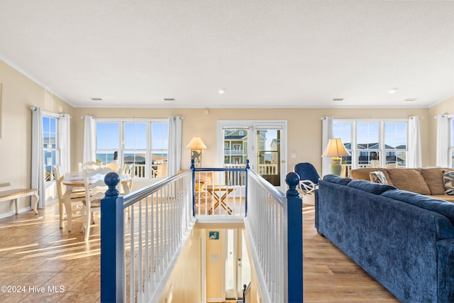 interior space featuring light wood-type flooring, baseboards, and ornamental molding