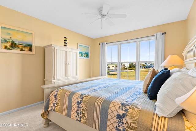 bedroom with light carpet, ceiling fan, and baseboards