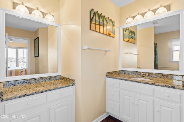 full bath featuring baseboards, a ceiling fan, and vanity