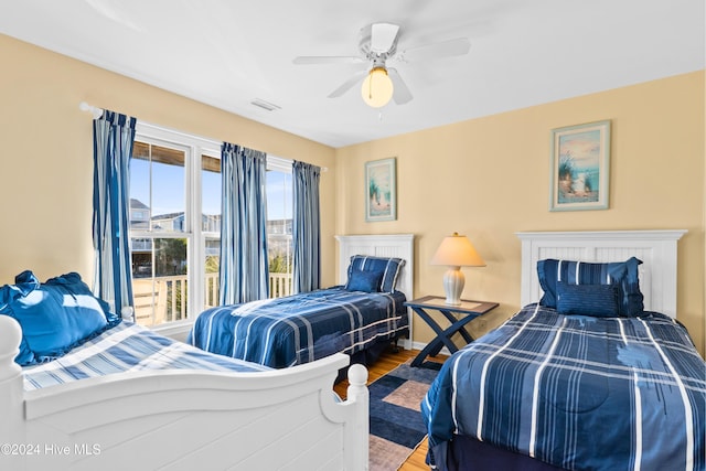 bedroom with ceiling fan, wood finished floors, visible vents, and baseboards