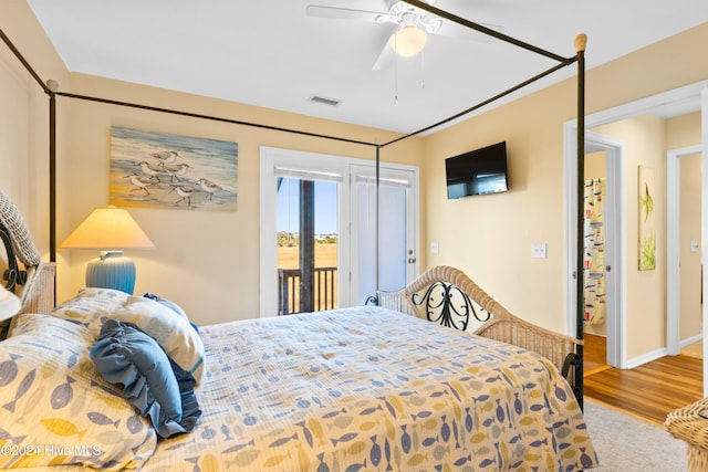 bedroom featuring access to exterior, visible vents, a ceiling fan, wood finished floors, and baseboards