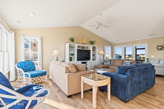 living room with lofted ceiling, light wood-style flooring, ceiling fan, and crown molding