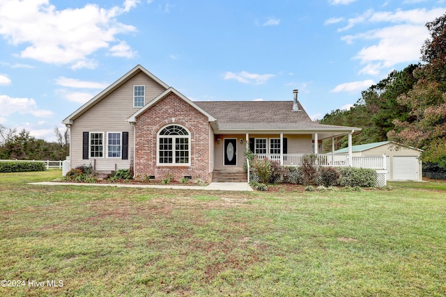 view of front facade featuring covered porch, a garage, an outdoor structure, and a front yard