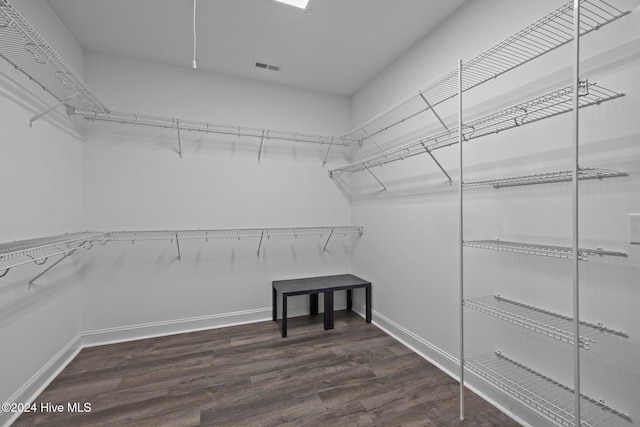 walk in closet featuring dark hardwood / wood-style floors